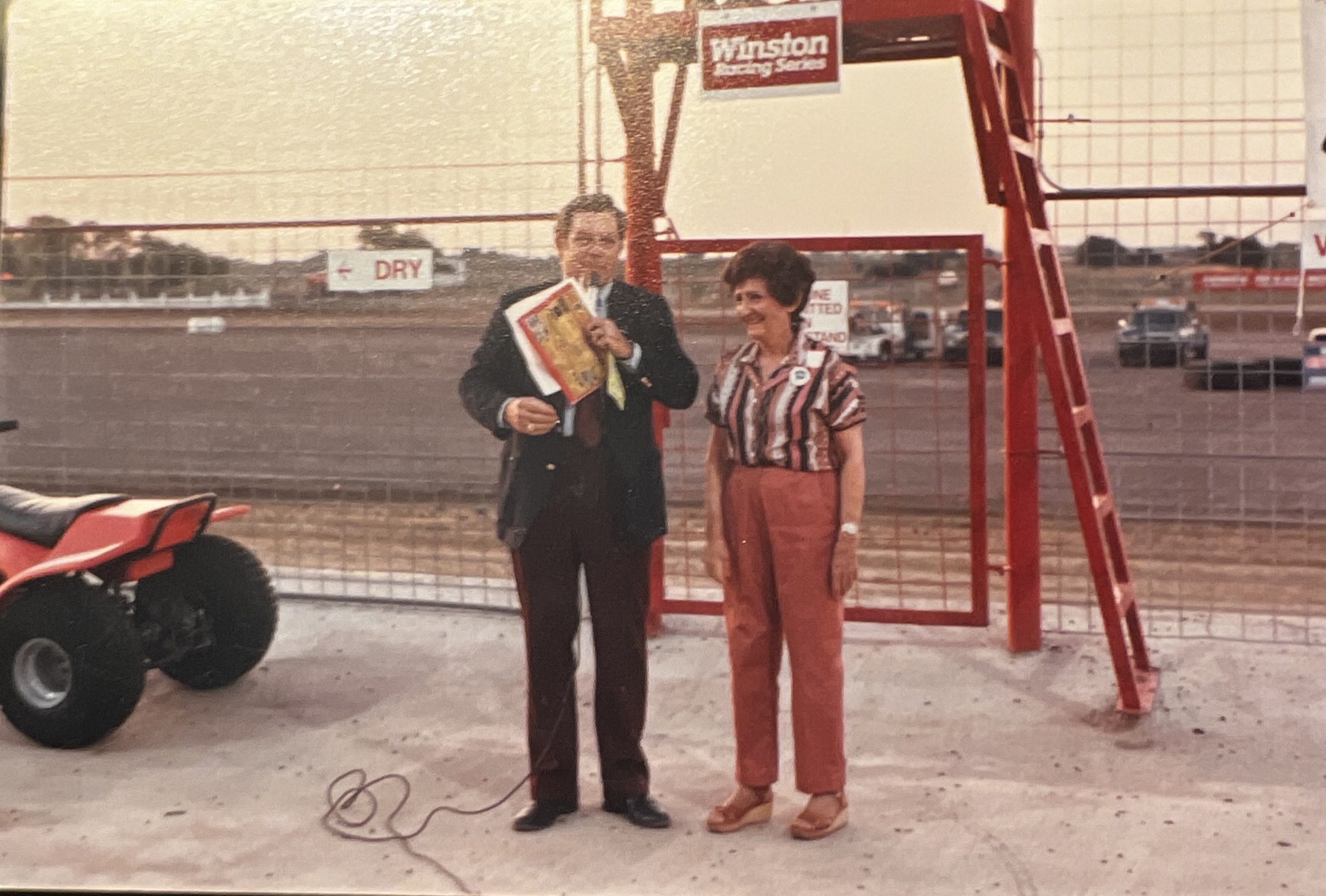 Andrew Hillman. His late grandmother waving the flag to start the car races at Royce City.