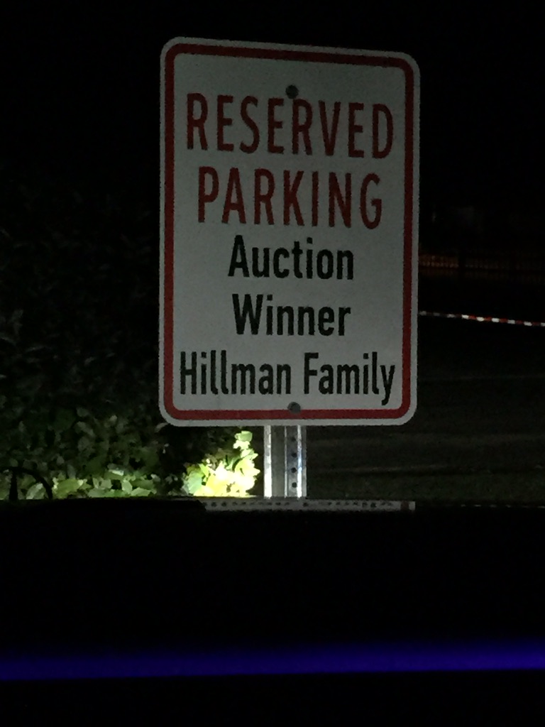 Andrew Hillman. Reserved parking sign at The Lamplighter School reading Auction Winner, Hillman Family
