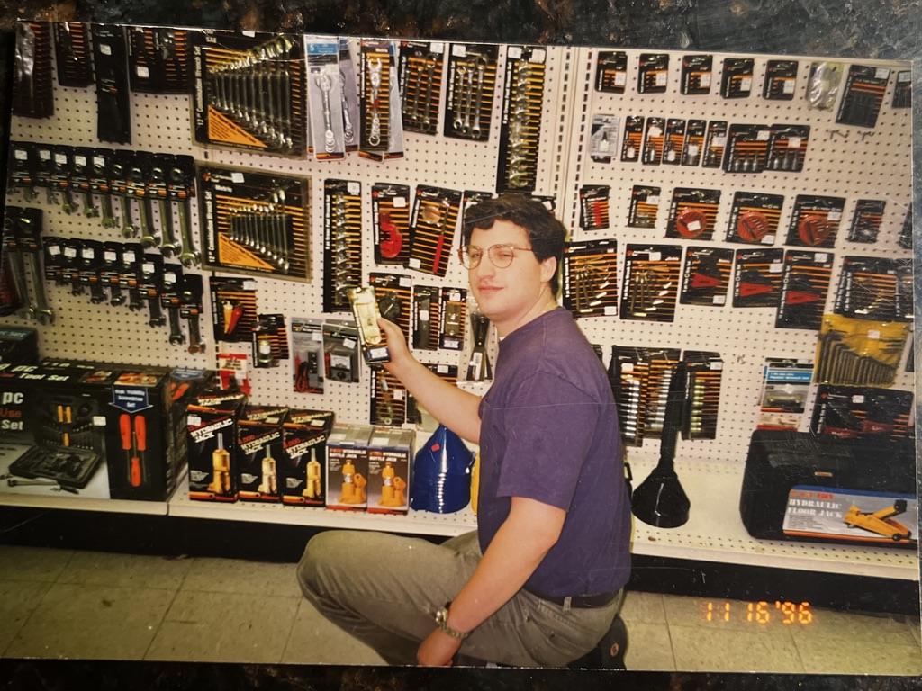 Andrew Hillman. Andrew stocking shelves at the family auto parts stores. Date stamp November 16, 1996.