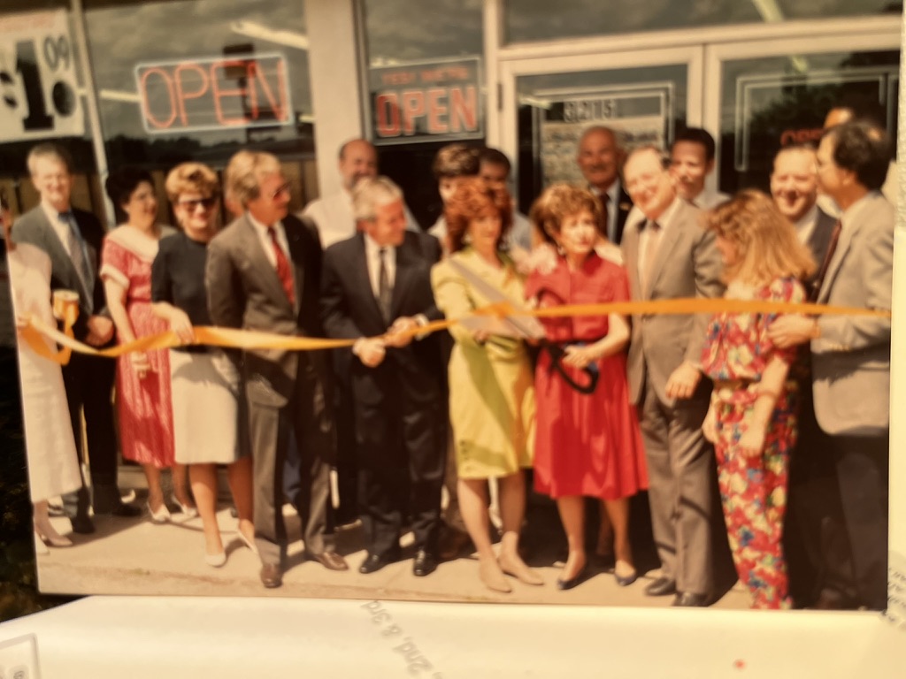 Andrew Hillman. Ribbon-cutting at the family business Midway Auto Supply. Address 3215 is on the storefront.
